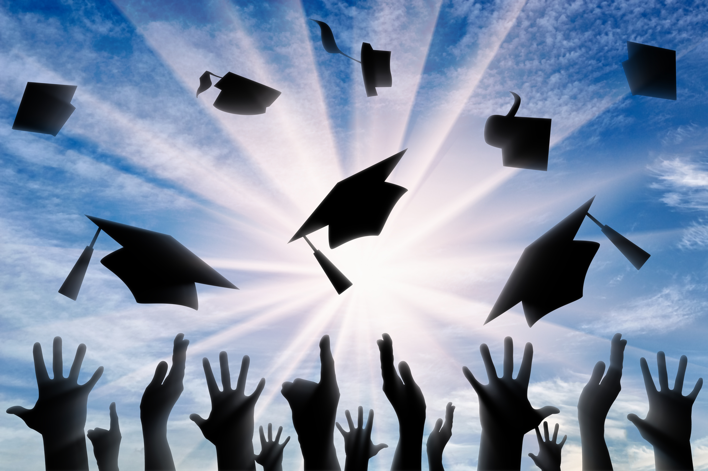 Graduation caps in air