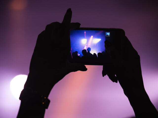 Concert-goer filming with phone