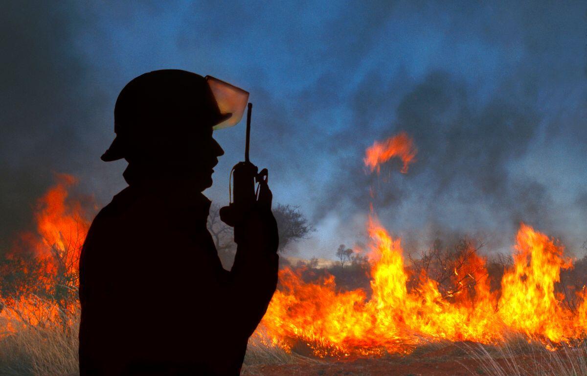 Firefighter at a wildfire on his radio