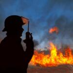 Firefighter at a wildfire on his radio