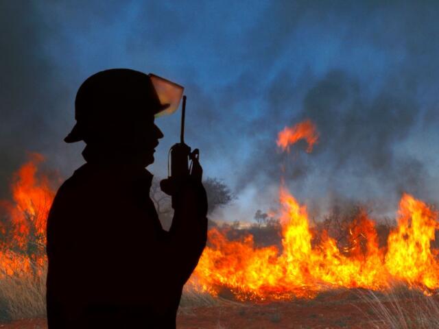 Firefighter at a wildfire on his radio