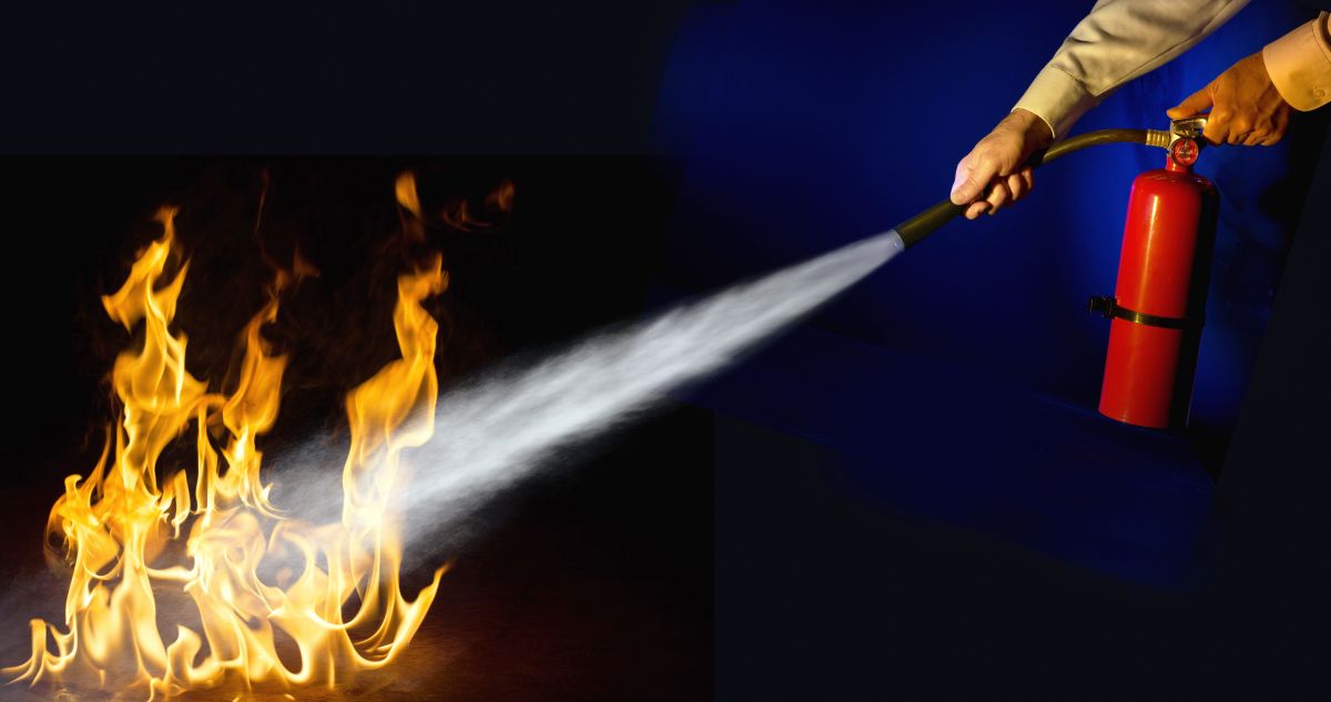 Person with fire extinguisher putting out fire
