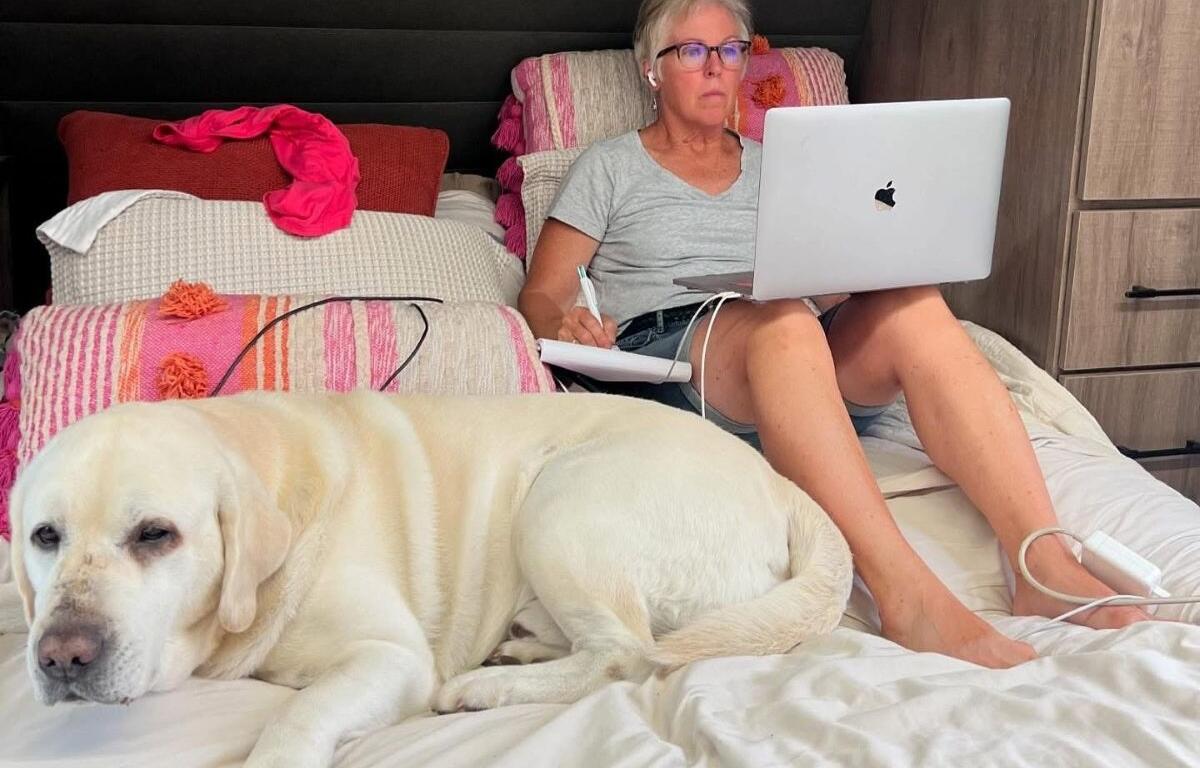 Denise Mazolla in her RV working with dog Gio