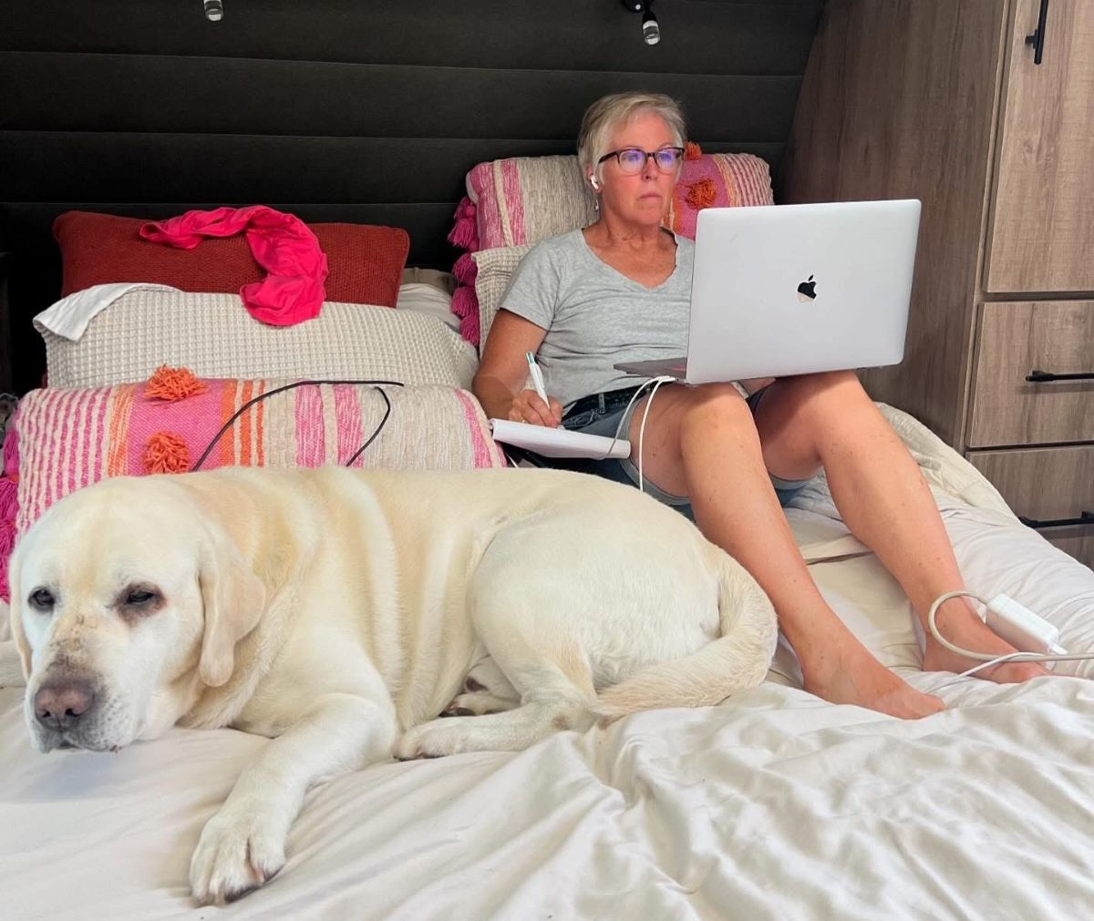 Denise Mazolla in her RV working with dog Gio