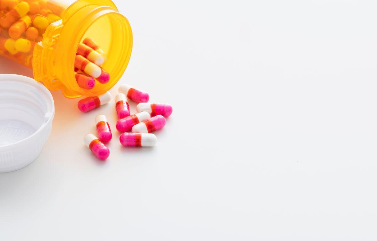 Pills spilling out of a pill bottle.