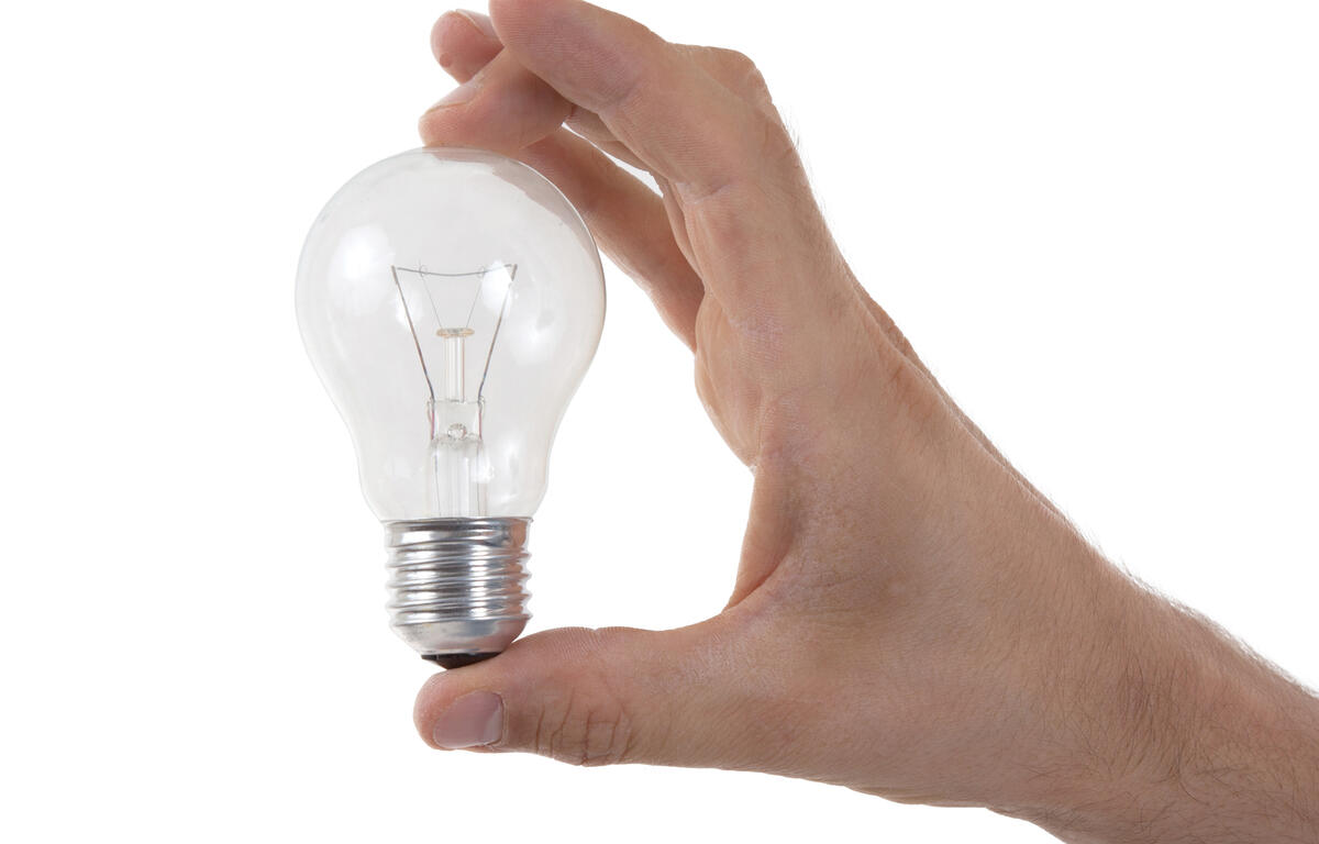 Hand holding lightbulb