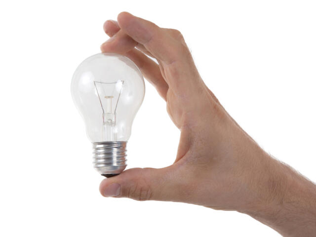 Hand holding lightbulb