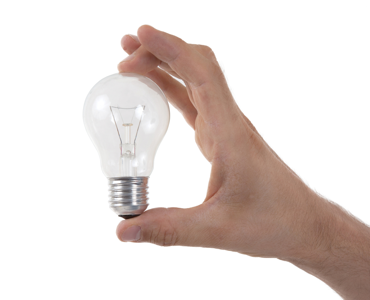 Hand holding lightbulb