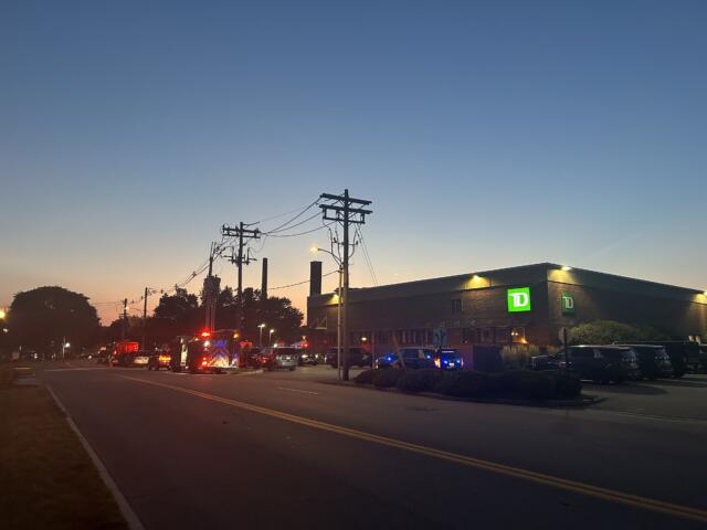 Emergency and police vehiucles gathered outside TD Bank on West Street after the five-hour standoff ended Tuesday.