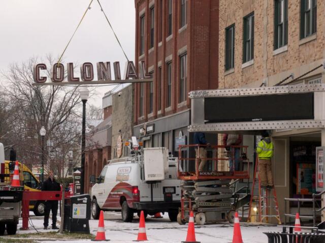 Taking down the lettering on the marquee at the Colonial Theatre to replace it