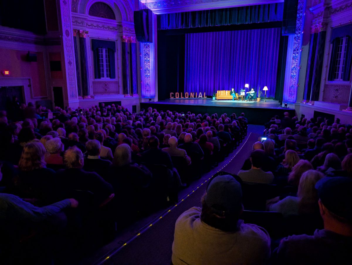 Colonial Theatre director Keith Marks interviews fillmaker Ken Burns after the American Revolution screening at the theater with the old marquee lettering onstage