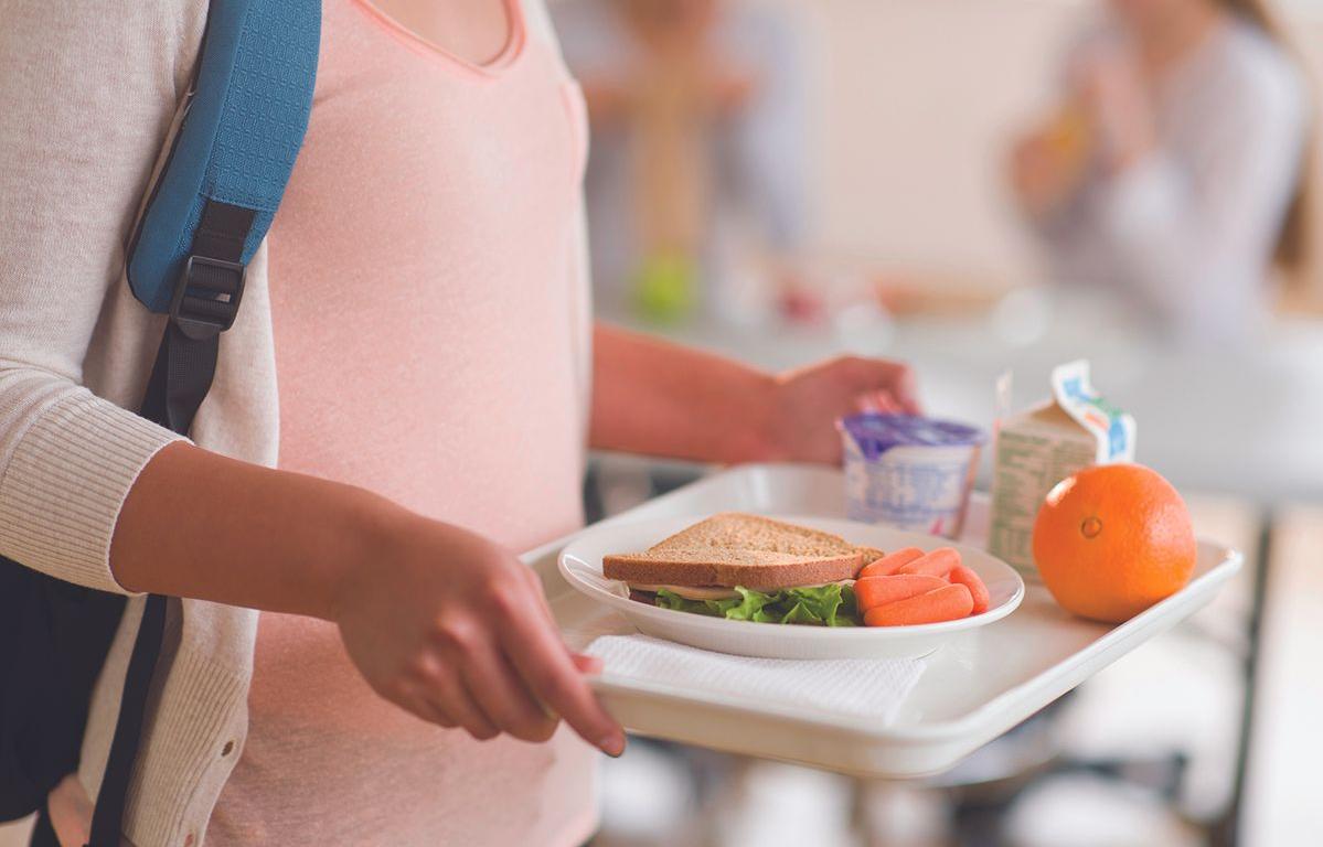Child holding lunch tray