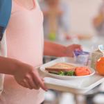 Child holding lunch tray