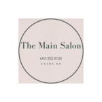 Poster-style ad reading 'The Main Salon' on a beige textured background with a dark circular arc and contact number (603-352-8128, Keene, NH).