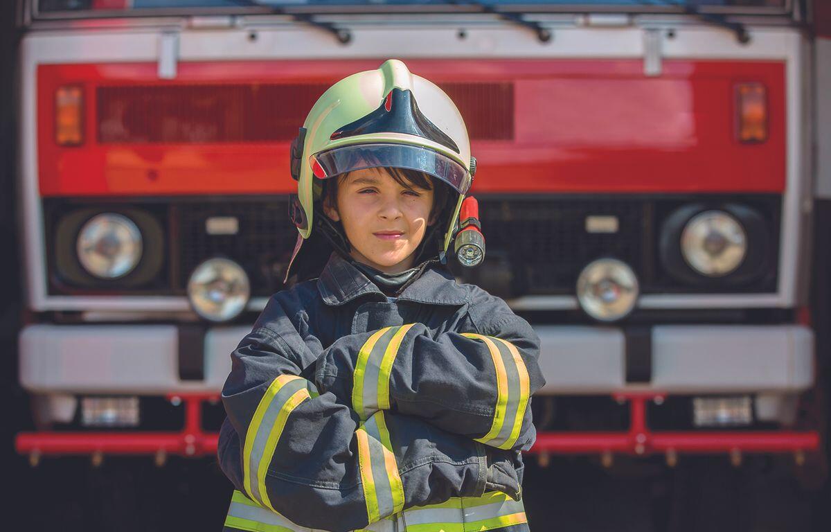 Kid in fireman's uniform