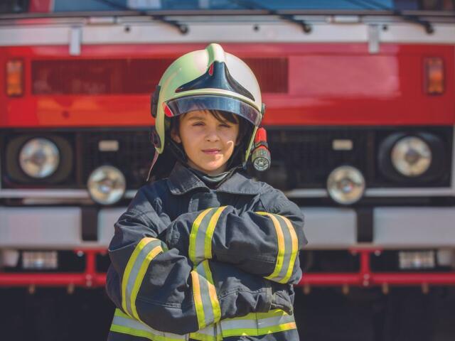 Kid in fireman's uniform