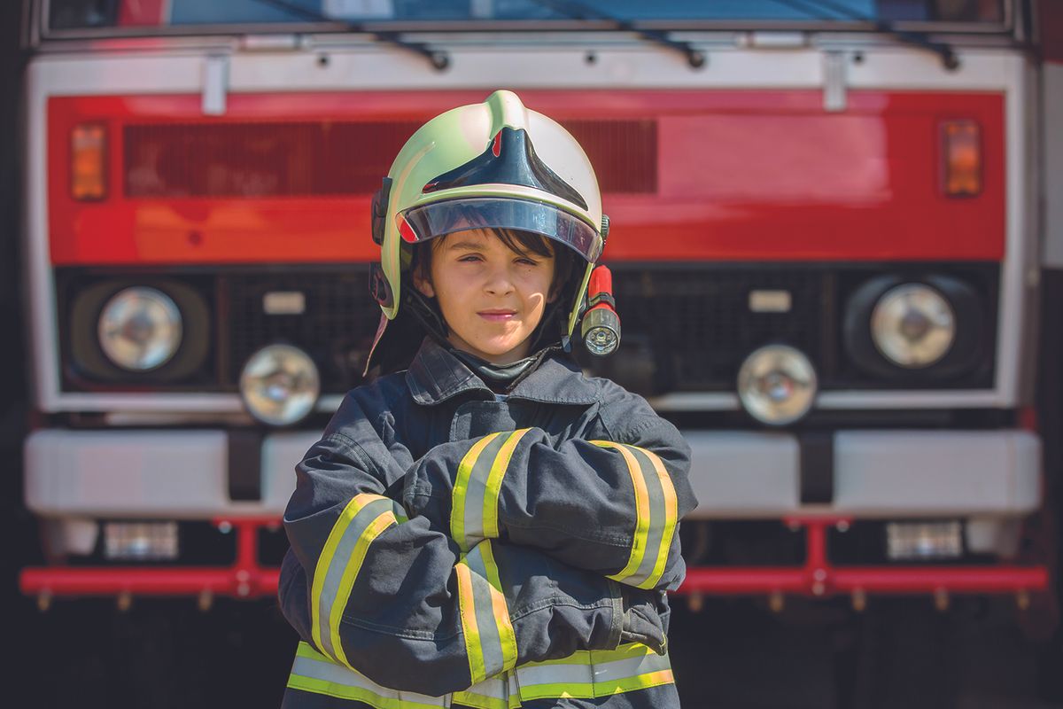 Kid in fireman's uniform